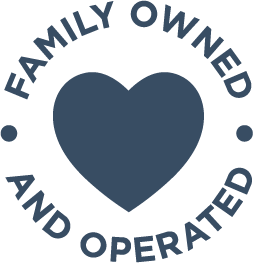 A dark blue heart icon is centered with the words Family Owned and Operated curved around it in a circular design.