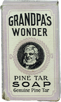 A vintage box of Grandpa’s Wonder Pine Tar Soap features a bearded man’s illustration and text reading “Genuine Pine Tar” on the front in bold and decorative fonts.