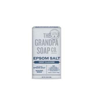 A white and blue Epsom Salt Bar Soap stands upright, featuring vegan, cruelty-free claims. Its packaging notes it's sulfate-, paraben-, and artificial fragrance-free, and enriched with cleansing Epsom salt.
