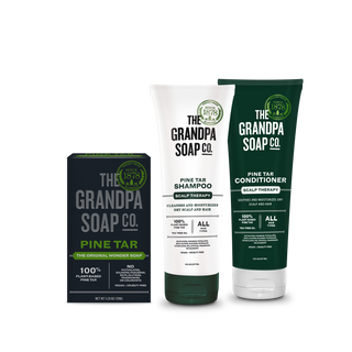 The Pine Tar Bar Soap and Haircare Bundle includes a boxed bar soap, shampoo, and conditioner for scalp therapy, all in green and white Grandpa Soap Co. packaging.
