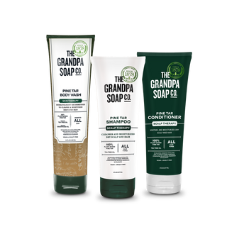 The Pine Tar Bundle Body Wash and Haircare Bundle from The Grandpa Soap Co., featuring body wash, shampoo, and conditioner labeled as scalp therapy, displayed on a white background.
