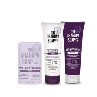 The Grandpa Soap Co.'s Witch Hazel Collection Bundle includes a lavender soap bar, a white and purple tube of shampoo, and a purple tube of conditioner.