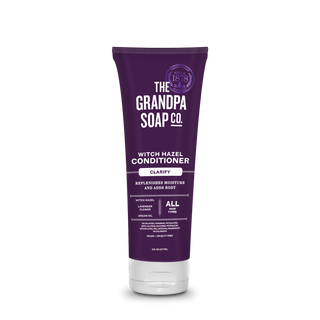 A purple tube of Witch Hazel Conditioner labeled Clarify, infused with witch hazel to replenish moisture and add body. It's vegan, cruelty-free, and suitable for all hair types.