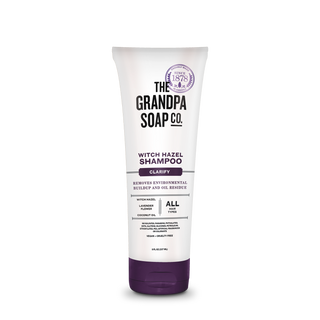 A tube of Witch Hazel Shampoo with a white and purple design, featuring clarifying hair benefits and key ingredients like witch hazel, lavender cleanser, and nourishing coconut oil.